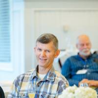 man listens to panel